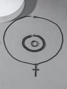 Detailed flat lay of black matte cross pendant necklace with matching Cuban chain bracelet and ring