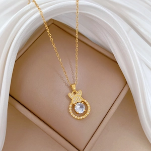 Detailed shot of gold butterfly ring pendant with large diamond on silk and jewelry box