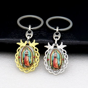 Macro view of Our Lady of Guadalupe metal keychains in gold and silver finishes