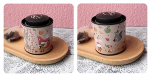 Detail of round tin canister with cute fox illustration and double lid closure