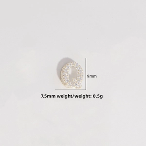 Macro detail of gold S925 silver letter Q pendant with cubic zirconia, 9mm x 7.5mm size