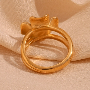 Detail of 18K gold plated stainless steel ring with vintage four-petal flower and natural stone