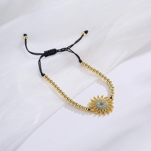 Adjustable sunflower charm bracelet with 18K gold beads and blue zircon crystals