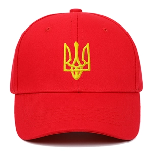 Close-up of bright red cotton baseball cap with yellow Ukraine trident embroidery detail