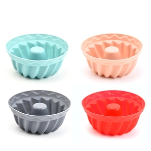 Colorful round silicone muffin cups for DIY baking in green, orange, grey, and red colors