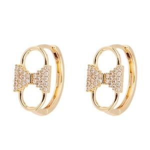 French vintage gold bow earrings with micro-set zircons on a clean white background