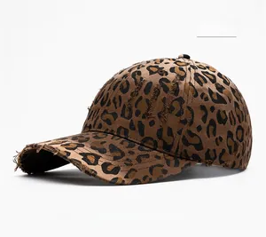 Detail view of coffee leopard print baseball cap featuring distressed torn brim effects