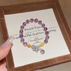 Elegant amethyst beaded snake bracelet with silver butterfly pendant in a jewelry box