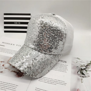 Close-up of shiny silver sequins and breathable white mesh on a stylish baseball cap
