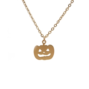 Detail of a golden pumpkin pendant with cutout smile and fine O-chain necklace