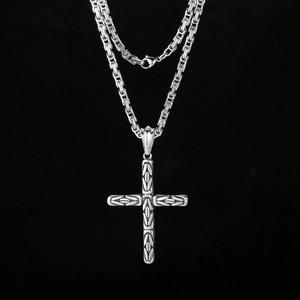 Silver Byzantine chain necklace with vintage cross pendant on black background