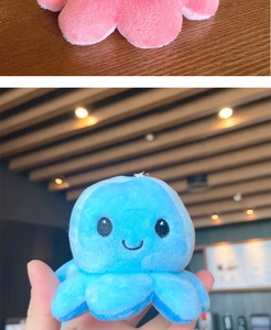 Detailed view of the reversible octopus plush keychain showing pink and blue flip states