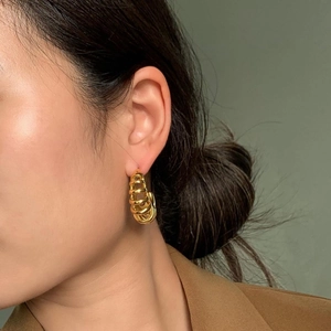 18k gold plated stainless steel C-shaped spiral hoop earrings worn by a model