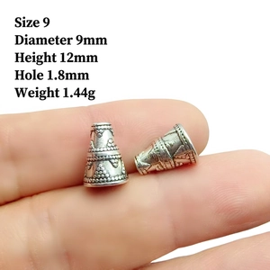 Macro detail of antique silver bead cap showing embossed floral texture and 9mm dimensions