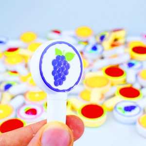 Close-up of novelty lollipop-shaped eraser with colorful grape fruit pattern detail