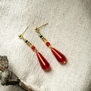 Detail of red water drop beads and gold cloud accents on vintage Chinese style earrings