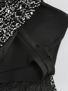 Detail of sequin dress featuring silver-black sequins and a black elastic safety lining