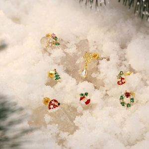 Detailed close-up of S925 silver Christmas earrings with crystals on snow background