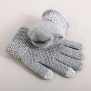 Close-up of grey knitted gloves with warm fleece lining and ribbed elastic cuffs