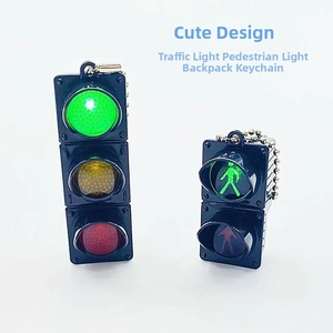 Macro detail of LED traffic light keychain and pedestrian signal with silver metal chain