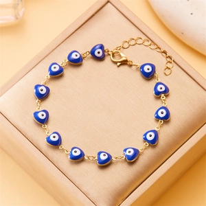 Golden chain bracelet with blue heart-shaped evil eye charms and lobster clasp