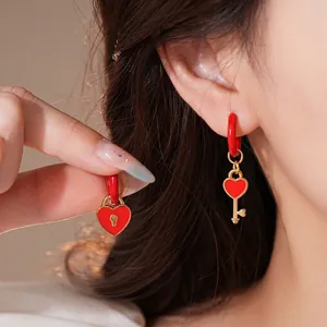 Asymmetric heart lock and key red enamel earrings in gold-plated stainless steel