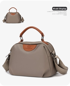 Close-up of khaki waterproof oxford fabric handbag with brown leather logo detail