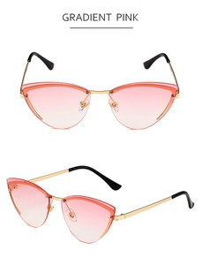 Detail view of cat eye sunglasses with gradient pink lenses and gold metal frame
