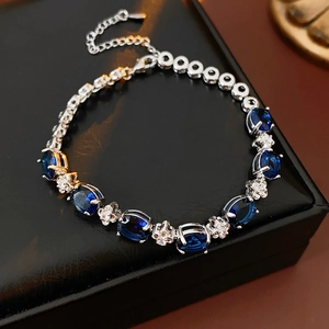 Macro shot of oval blue zircon flower bracelet with adjustable silver extension chain