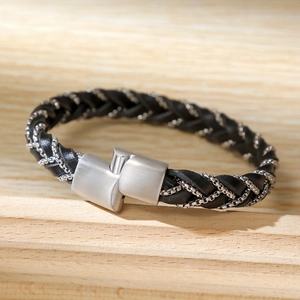 Detail of hand-woven black microfiber and silver stainless steel chain bracelet with buckle