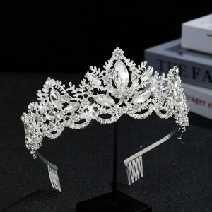 Detail view of silver crystal bridal crown with marquise-cut rhinestones on black stand