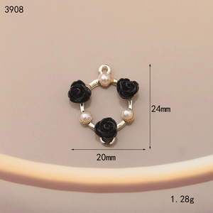 Detailed view of black enamel rose charm with pearl accent and 24x20mm dimensions