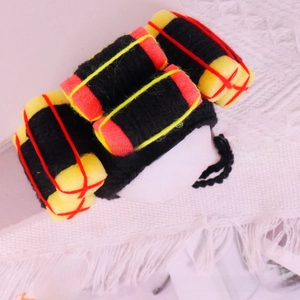 Detailed view of handmade knitted dynamite shaped funny pet headwear accessory