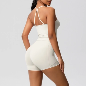 Close-up of light gray yoga set with spaghetti strap top and high-waist biker shorts