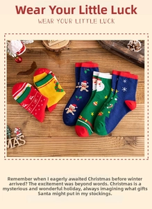 Detail of Christmas cotton socks featuring Santa and reindeer patterns on a wood surface
