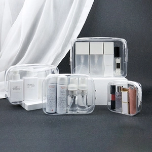 Detailed set of four transparent PVC travel makeup bags with sturdy zippers for storage