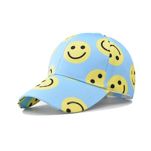 Close-up of sky blue cotton baseball cap with yellow smiley face prints and curved brim