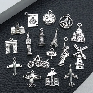 Detailed set of 16 silver alloy travel themed charms including Eiffel Tower and Passport