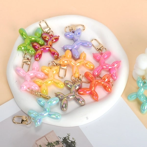Colorful balloon dog keychain collection with metallic gradient finish and gold lobster clasp