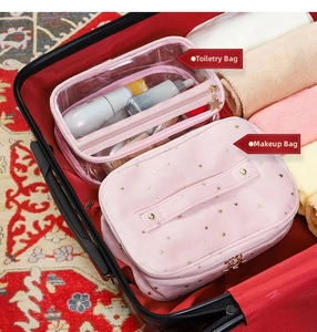 Pink velvet vanity bag and transparent toiletry kit set inside a red suitcase