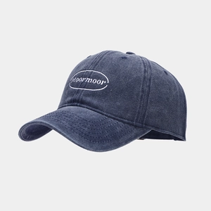Detailed view of deep blue vintage washed cotton baseball cap with moormoor embroidery