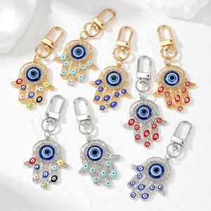 Set of 8 vintage gold and silver Hamsa Hand keychains with colorful Evil Eye charms