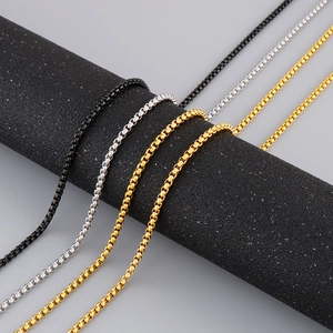 Macro shot of stainless steel Venetian chains in black, silver, and gold finishes