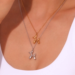 Minimalist 18K gold and silver plated balloon dog pendant necklace on a model