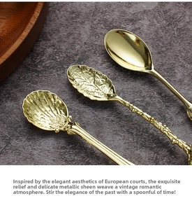 Detailed macro view of vintage gold coffee spoons with intricate floral engravings