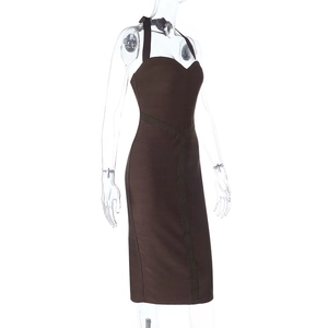 Close-up detail of coffee brown bandage fabric and ribbed texture on the halter dress