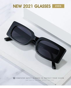 Detail of vintage square black sunglasses with dark gray lenses on a white display
