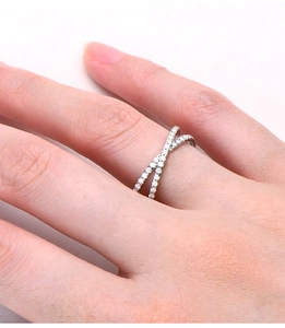 Close-up of S925 sterling silver X-shaped ring with micro-pave clear moissanite on finger