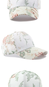 Detailed close-up of intricate Chinese scenery embroidery on a white cotton baseball cap