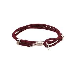 Close-up of deep red braided bracelet featuring a silver metal whale tail clasp closure